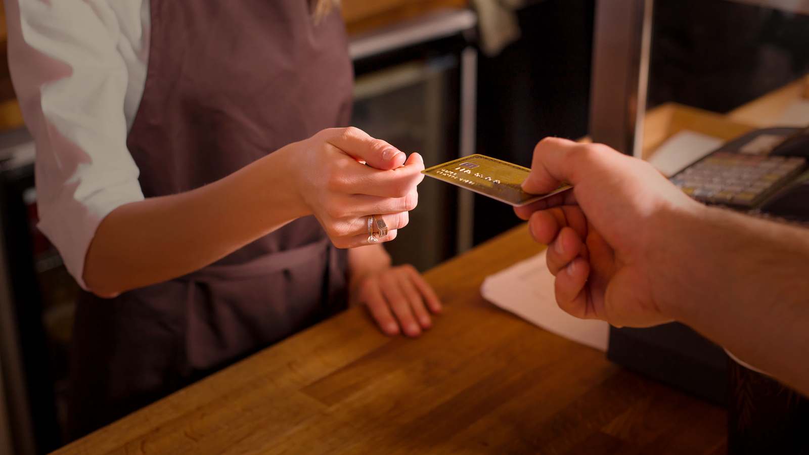 Cash advance business credit card changing hands at a shop counter