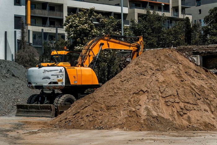 Heavy equipment financing: a wheeled excavator beside a pile of earth on a building site