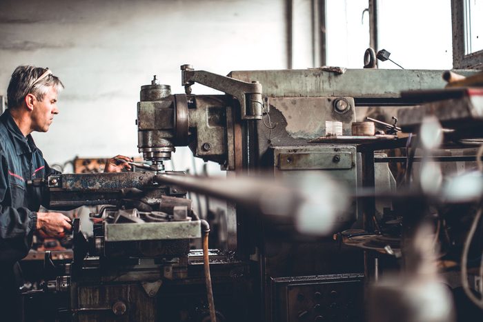 Loan for used machinery purchase: a machinist working at an old lathe in a workshop