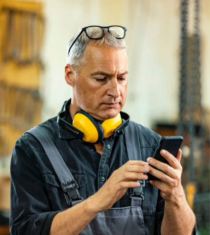 A Cardiff small-business customer checking his phone